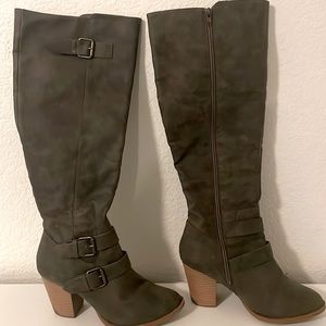 Tall dark knee high heeled boot